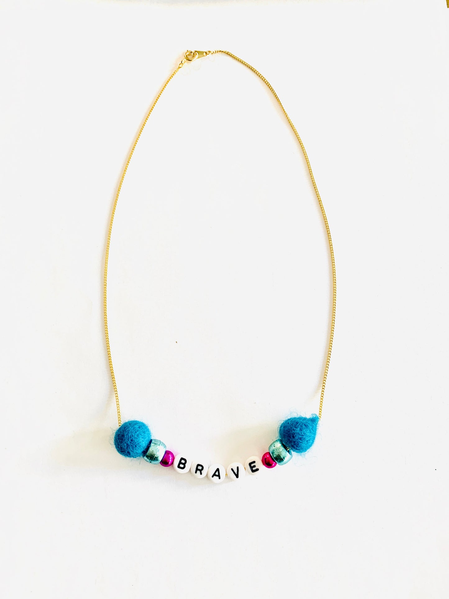 brave meaningful pom pom necklace